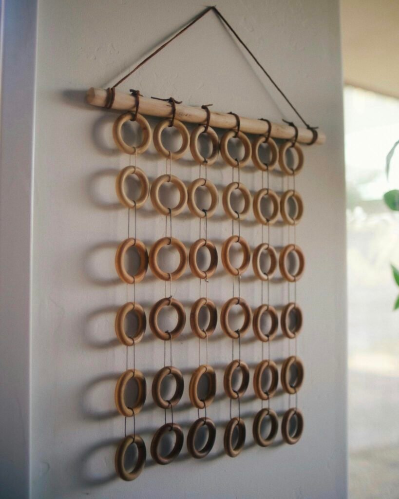 A rustic boho wall hanging made of wooden rings, perfect for minimalist decor.